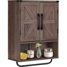 a wooden cabinet with two doors and some candles