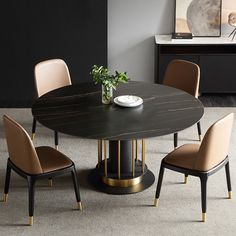 a dining table with four chairs around it and a vase on the table in front of it