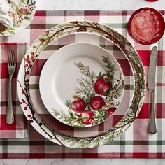 the table is set with dishes and utensils