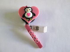 Adorable Penguin on a pink heart attached to a ID Badge retractable reel with your name on a pink bar attached to the badge.  The name on the picture is a sample.  Please e mail me the name you want at the time of purchase.  It can be no more than 7 letters. Novelty Pink Badge Holder For Birthday, Cute Pink Badge Reel For Birthday, Customizable Adjustable Pink Badge Holders, Novelty Pink Badge Reel, Fun Pink Badge Holders For Gift, Fun Pink Badge Reel For Gift, Adjustable Novelty Pink Badge Holders, Cute Pink Badge Holders For Gift, Cute Pink Badge Holder As Gift