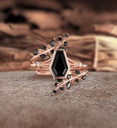 a black diamond ring sitting on top of a rock