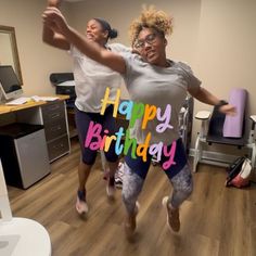 two women are dancing in an office with the words happy birthday written on their t - shirts