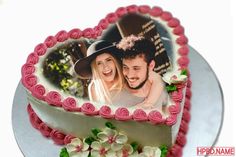 a heart shaped cake with two photos on it