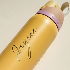 a yellow and pink water bottle with the word dance written in cursive writing