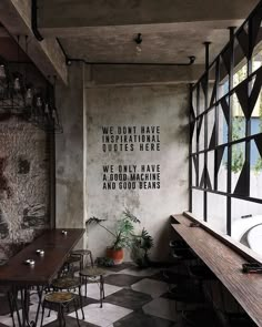 an empty restaurant with tables and chairs in front of a wall that reads we don't have uninspiring unless here