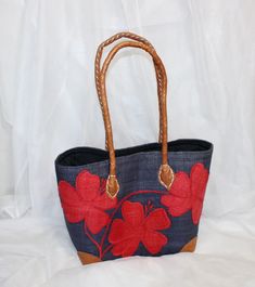 This cute woven straw tote has a hibiscus flower design that is red on blue with a black drawstring cover. It has leather straps with a cloth drawstring cover and a faded looked, and it is in great vintage condition. It measures 9 inches tall and roughly 12 inches at its widest and just under 6 inches deep.  Wear consistent with age mostly to bottom corner leather covers. I would assume it is hand made. A cute spring/summer look, great for transporting a small project. Coco and Coffee Vintage offers sweet vintage finds and handmade items for the eclectic home, as well as vintage and handmade jewelry and accessories for women and men. Thanks for checking out my shop! Summer Red Straw Bag With Leather Handles, Red Straw Bag With Adjustable Strap For Beach, Red Straw Bag With Leather Handles For Daily Use, Red Straw Bag With Leather Handles For Beach, Red Straw Bag With Adjustable Strap For Vacation, Casual Red Beach Bag With Adjustable Strap, Red Basket Bag For Vacation, Red Casual Straw Bag For Travel, Casual Red Straw Bag For Travel