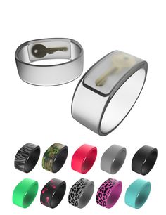 an assortment of different colored rings with a key in the middle and various colors on each ring