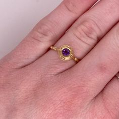 This stunning amethyst set in yellow gold is is sure to take your breath away! This ring provides a look that is very modern yet classic. This ring is very fashionable and can add a touch of style to any outfit, yet it is also classy enough to pair easily with formal wear. It looks beautiful by itself but also looks wonderful in a stack or as a wedding band! This ring would make the perfect gift for yourself or your loved one!14K Yellow GoldGemstone: AmethystGemstone Weight: .22 CaratsGemstone S Luxury Yellow Gold Amethyst Ring With Bezel Setting, Luxury Purple Ring With Bezel Setting, Modern Gold Amethyst Ring, Luxury Gold Amethyst Ring With Bezel Setting, Modern Gold Oval Amethyst Ring, Elegant Yellow Gold Amethyst Open Ring, Modern Gold Amethyst Ring With Oval Shape, Modern Gold Sapphire Ring With Center Stone, Elegant Gold Solitaire Amethyst Ring