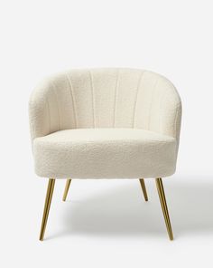 a white chair with gold legs on a white background