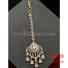 Ruby White Rose Gold CZ Round Mang Tika Mang Tika: Approx. 5 Inches Hook feature to tie the mang tika to hair Made in Brass with very high quality CZ stones Lightweight Jewelry Suitable for any occasion and traditional or Modern attire Ready to ship and available for local pickup from 23059. Please message us for more details Free shipping on orders above $75 within USA. Traditional Adjustable Tikka With Stone Work, Adjustable Stone Work Tikka For Ceremonial Occasions, Traditional White Adjustable Tikka, White Stone Work Tikka As Gift, White Stone Work Tikka For Gifts, Elegant Adjustable Tikka As Gift, Adjustable Elegant Tikka As Gift, Adjustable Elegant Tikka Gift, Elegant Adjustable Tikka For Ceremonial Occasions