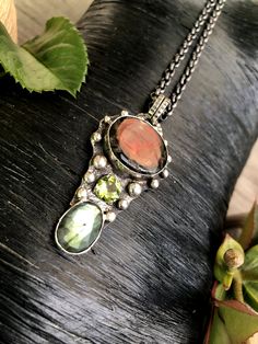 "Artisan Ammolite Fossil Gemstone Pendant Necklace Hand-made Sterling Silver 925 Stones used: Ammolite-Fossil, Labrodorite, Peridot. Height - 2 1/2\" (with bail), Width - 1 1/8\" Height -62mm (with bail), Width - 28mm Unique Handcrafted One-of a-kind Design Each Piece of Jewelry in my Collection is Absolutely One of a Kind! When you start wearing a piece of my jewelry you will fall in love with it more and more each day and feel that good Energy and Love that I pass into it while creating this p Artisan Necklace With Natural Tourmaline Stones, Artisan Multi-stone Oval Necklace, Artisan Tourmaline Necklace With Natural Stones, Handmade Tourmaline Artisan Necklace, Handmade Artisan Tourmaline Necklace, Unique Tourmaline Gemstone Necklace, Fusion Style Tourmaline Jewelry With Natural Stones, Artisan Hand Forged Sterling Silver Necklace, Unique Multi-stone Sterling Silver Necklace