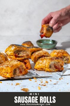 Mini sausage rolls on a white background with a hand dipping a sausage roll into tomato sauce. Mini Sausage Rolls, Puff Pastry Crust, Sausage Roll, Festive Appetizers, Appetizers For A Crowd, Best Christmas Recipes, Delicious Appetizer Recipes, Flaky Pastry, Homemade Recipe