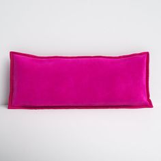 a bright pink pillow on a white background