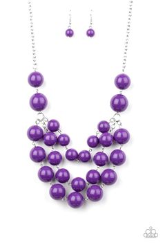 Three strands of bubbly purple beads cascade below the collar, creating colorful layers. Features an adjustable clasp closure. Sold as one individual necklace. Includes one pair of matching earrings. Cheap Purple Plastic Jewelry, Luxury Purple Round Bead Jewelry, Luxury Purple Round Beaded Jewelry, Purple Beaded Chain Jewelry For Party, Purple Dangling Beads Jewelry For Party, Purple Large Beaded Necklace, Purple Necklaces With Dangling Beads, Purple Jewelry With Colorful Beads For Party, Purple Party Jewelry With Colorful Beads