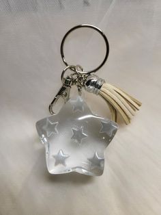 a star shaped glass keychain with a tassel