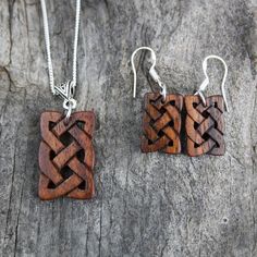 "This beautiful and unique hand-carved wooden Celtic knot jewelry set will be made for you, or a loved one, in my studio on the West of Ireland. These dainty rosewood Celtic necklace & earrings are recycled from musical instruments constructed by a local luthier. As a musician myself, I take enormous satisfaction in creating a jewelry set whose inherent wood has previously featured in a beautiful hand-made guitar. Also, part of rosewood's attractiveness is its durability and ability to stand Handmade Wooden Pendant Jewelry, Handmade Artisan Wood Jewelry, Artisan Wooden Jewelry As A Gift, Artisan Handmade Wooden Jewelry, Handmade Artisan Mahogany Jewelry, Artisan Wood Jewelry Gift, Artisan Handmade Mahogany Jewelry, Rustic Wooden Beads Jewelry As A Gift, Traditional Handmade Natural Wood Jewelry