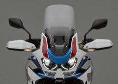 the front view of a white and blue motorcycle with red, white, and blue accents