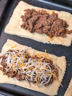 two uncooked pita breads with cheese and ground beef on top, sitting on a baking sheet