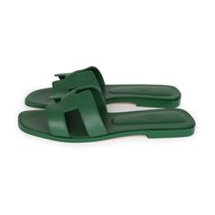 This pair of Oran Sandals are in Vert Electrique Calfskin with the iconic H crossover strap, Vert Electrique Goatskin insole, leather heel, and natural leather sole.Origin: ItalyCondition: New and never wornAccompanied by: Hermes box, dustbags, and carebookSize: 38 EU Luxury Green Leather Sandals, Luxury Green Sandals With Single Toe Strap, Green Flat Sandals With Leather Sole, Green Leather Flat Slides, Luxury Green Closed Toe Sandals, Designer Green Sandals With Single Toe Strap, Summer Calf Leather Slides With Removable Insole, Summer Calf Leather Slides With Flat Heel, Summer Slides With Flat Heel In Calf Leather