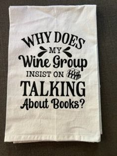 a tea towel that says why does my wine group insist on talking about books?