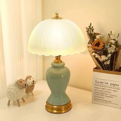 a lamp sitting on top of a table next to a stuffed animal