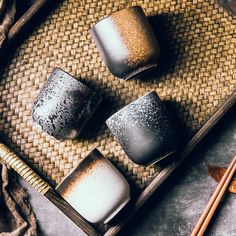 three different kinds of candles sitting on top of a tray next to chopsticks