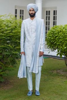 Blue sherwani with resham, dabka embroidery in floral motifs. Paired with kurta, trouser, embroidered border stole and turban.
Component: 5
Pattern: Embroidered
Type Of Work: Resham, Dabka, Glass beads
Neckline: Mandarin
Sleeve Type: Full
Fabric: Raw Silk
Color: Blue
Other Details: 
Weight (in kg): 1.5
Floral motifs
Occasion: Wedding - Aza Fashions Blue Sherwani, Embroidered Sherwani, Sherwani Groom, Vacuum Storage, Indian Man, Beaded Neckline, Fashion App, Sherwani, Embroidered Silk