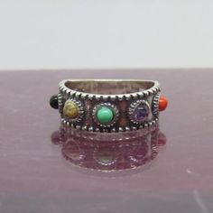 Vintage Sterling Silver Mixed Gemstones Band Ring....Marked 925....Total weight of 3.9g...Measure of Face 7.3MM....it's in very good condition. Spiritual Multi-stone Promise Ring, Spiritual Open Ring With Stones, Spiritual Open Rings With Stones, Adjustable Multi-stone Stackable Rings, Spiritual Round Stone Rings, Adjustable Multi-stone Rings, Sterling Silver Multi-stone Turquoise Ring, Sterling Silver Round Turquoise Multi-stone Ring, Sterling Silver Stackable Rings With Multi-stone