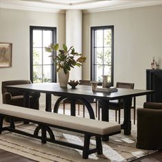 a dining room table with bench and chairs