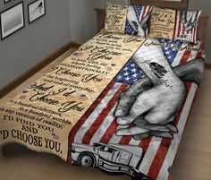 a bed with an american flag and two hands holding each other's hand on it