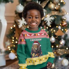 a young boy wearing a christmas sweater in front of a tree