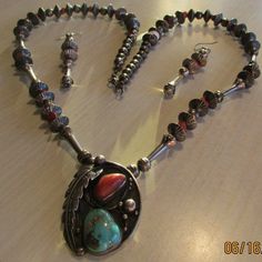 "Beautiful sterling silver coral and turquoise Navajo necklace. Not signed. The pendant is 1 7/8\" tall x 1 3/8\" wide. The necklace is 28\" of sterling silver hogan and bench made beads and coral beads. There are also some squash blossom like beads. All have natural patina and are in good condition. There are matching 2 1/8\" beaded earrings which hang from silver hooks or wires. Shipped by US first class mail and insured. BDS-1" Southwestern Jewelry With Oxidized Finish, Collectible Turquoise Necklace With Natural Stones, Navajo Necklace, Squash Blossom, Necklace And Earring Set, Silver Jewelry Handmade, Coral Beads, Tucson, Handmade Silver