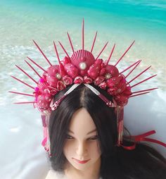 Hot pink mermaid crown for adult is absolutely lovely and would be lovely for a photoshoot, beach wedding, or mermaid costume adult, burning man clothing for women, mermaid festival crown, siren cosplay or mermaid cosplay. This Siren headpiece will be an excellent complement to mermaid party outfit for women. DIMENSIONS: - This Seashell crown is suitable for adults. - The height of the spiked is about 5.6 inches (13 cm). - The spikes are made with wood. The spikes are painted with hot pink acrylic paint. - The crown is decorated with rhinestone, beads and natural shells. - The crown on the head can be secured with a ribbon. - This crown is beaded and decorated with strings of beads that I collected by hand. - This crown is unique, made in one instance. 100% repetition is not possible. Only Pink Pinched Crown For Party, Whimsical Teardrop Crown Headpiece For Festivals, Adjustable Pink Headpiece For Costume Party, Bohemian Costume Hat With Structured Crown For Festivals, Bohemian Crown Costume Hat For Carnival, Bohemian Crown For Carnival, Whimsical Adjustable Pink Crown, Adjustable Pink Crown With Round Shape, Whimsical Pink Costume Hats And Headpieces For Carnival