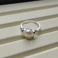 🤍 Gorgeous looking!! Freeform Style Cultured Pearl Ring. Metal: 925 Sterling Silver. Stones: Cultured Pearl, CZ Ring Size: Can be selected Stone Size: 8 mm Total Weight: 2.6 grams Anti-tarnishing coated 🤍  Add a touch of elegance to your jewelry collection with this stunning pearl ring. Crafted from 925 sterling silver, this ring features a cultured off white pearl stone accentuated with sparkling cubic zirconia. The round shape of the pearl and cubic zirconia its excellent cut grade make it a Sterling Silver Open Pearl Ring Fine Jewelry, Sterling Silver Open Pearl Ring, Sterling Silver White Gold Pearl Ring With Pearl Drop, Elegant White Gold Pearl Ring Stamped 925, Sterling Silver Pearl Drop Ring In White Gold, White Pearl Drop Ring For Anniversary, White Gold Sterling Silver Rings With Pearl Drop, White Gold Pearl Drop Ring In Sterling Silver, Sterling Silver Hallmarked Pearl Ring For Promise