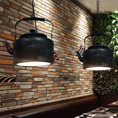 two lamps hanging from the ceiling in a restaurant