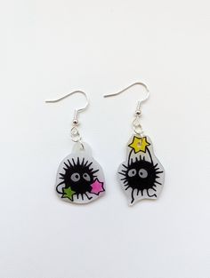 the earrings are decorated with black and white images, one has a star on it