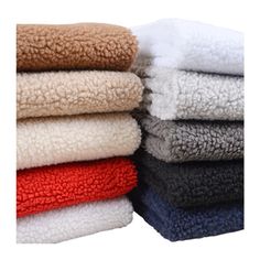 towels stacked on top of each other in different colors and sizes, with one folded over the