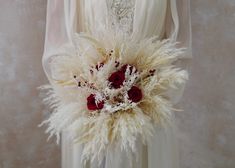 a bridal bouquet with white and red flowers