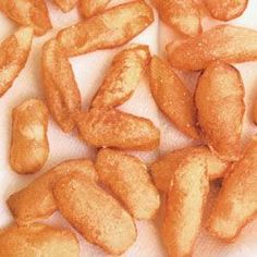 some fried food is laying out on a white paper towel and ready to be eaten