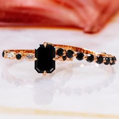 a black diamond ring sitting on top of a table