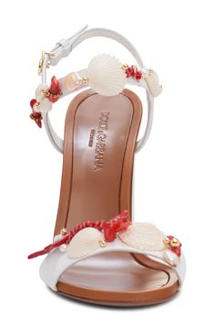 Deep-sea treasures of shells and freshwater pearls detail the straps of this summery sandal lofted by high half-round heel. 4" (102mm) heel Adjustable ankle strap with buckle closure Leather, synthetic and freshwater pearl upper/leather lining/leather and synthetic sole Made in Italy Designer Shoes Strap Sandals Women, Deep Sea, Strap Sandals, Designer Shoes, Freshwater Pearls, Ankle Strap, Capri, Dolce And Gabbana, Shells