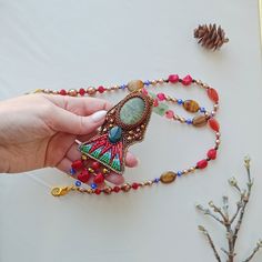 Bright pendant. Embroidered with beads and natural stones. Beautiful necklace. The inside is made of genuine leather.  Holiday accessory.  Can be an unusual gift The pendant can be paired with Egyptian-style earrings https://www.etsy.com/listing/1334551463/egyptian-earrings-embroidered-ethnic?click_key=a8fc11c3c19248eb231b68534e917b840e8d7bf1%3A1334551463&click_sum=cb9f4ba2&ref=shop_home_active_1&frs=1 Scarab pendant https://www.etsy.com/listing/1295039485/scarab-beetle-pendant-beaded-necklace?click_key=c16fb7719af6babca3ac7f2d3fb05604bb5c3ea9%3A1295039485&click_sum=4c38c71c&ref=shop_home_active_19&frs=1 Bohemian Brown Beads Gems And Cabochons For Gifts, Bohemian Brown Beads And Cabochons For Gifts, Bohemian Brown Beads Gems For Gifts, Amulet Style Beaded Necklace With Large Pendant Gift, Artisan Beaded Necklaces With Large Pendant Gift, Bohemian Handmade Pendant Beads, Gems, And Cabochons, Handmade Bohemian Pendant Beads, Gems, And Cabochons, Handmade Artisan Beads, Gems, And Cabochons For Gifts, Handmade Artisan Beads Gems And Cabochons For Gifts