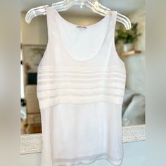 Express White Sleeveless Top Medium Front Has A Subtle Metallic Front Layer With A Horizontal Pleating Design Double Layer Front Single Layer Jersey Back Armpit To Armpit: ~19” Length From Shoulder: ~25.5” If You Are Brand New To Poshmark, Use Code Cem_poshmark At Checkout For $10 Off Your First Order. Fitted Tank Strap Tops For Daywear, Fitted Tops With Tank Straps For Daywear, Fitted Vest For Summer Layering, Elegant Summer Lace Tank Top, Stretch Sleeveless Camisole For Daywear, White Layering Camisole Top, Spring Daywear Tops With Scoop Neck, Fitted Sleeveless Daywear Camisole, White Camisole Top For Layering