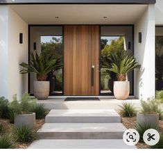 the front entrance to a modern home with two large planters on either side of the door