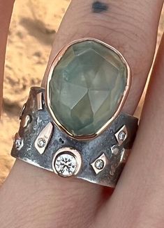 One of a kind Large , beautiful Prehnite ring with lab created diamonds, sterling Silver and 14k solid Gold Ring. Sterling Silver ring with Prehnite set in 14k solid gold bezel and gold elements on the band -oxidized  -Band Width : 12mm -Thickness: 1,5mm  -Lab created diamond 0.14ct  -Lab created diamonds 0.03ct (5pcs) Fits a size 6  This one of a kind statement Ring in Solid 925 Sterling Silver and 14k Gold is absolutely beautiful.  Handcrafted Ring Ring will be packed in a beautiful gift bag and box - ready for giving! PLEASE NOTE-  We offer standard free shipping worldwide (You will receive your order within 7 - 21 business days) And we also offer express shipping with FedEX courier (for additional cost, but You will receive your order within 2 - 5 business days) Please check out my ets Unique One-of-a-kind Sapphire Ring For Anniversary, Bohemian Rings With Gemstone Accents For Anniversary, Bohemian Anniversary Rings With Gemstone Accents, Unique Crystal Open Ring With Gemstone Accents, Unique Emerald Ring For Anniversary, Unique Green Rings With Rose Cut Diamonds, Unique Crystal Ring With Gemstone Accents For Anniversary, Unique Emerald Ring With Stone Setting For Anniversary, Unique Diamond Ring With Accent Stones