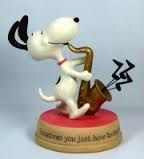 a figurine of a dog playing the saxophone