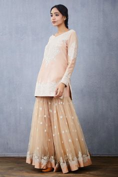 Peach short kurta with floral hand embroidered motifs. Paired with embroidered tulle sharara and embroidered tassel tulle dupatta.
Component: 3
Pattern: Embroidered
Type Of Work: Floral
Neckline: V Neck
Sleeve Type: Full Sleeves
Fabric: Kurta: Handwoven Chanderi, Sharara and Dupatta: Tulle
Color: Peach
Other Details: 
Hand embroidery
Tassel dupatta
Floral motifs
Occasion: Bride,Wedding - Aza Fashions Indian Wedding Lehenga, Peach Shorts, Wedding Lehenga, Full Sleeves, Fashion Shop, Festival Wear, Aza Fashion, Full Sleeve, Wedding Bride