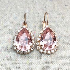 "Heatherly Designs™ dangling earrings featuring genuine Swarovski® crystals in blush pink surrounded by a delicate pave halo of smaller Swarovski® crystals in crystal faux diamond. The earrings are solid brass that has been plated. ●Nickel free ●Size (L x W): 1\" x .5\" or 28 x 13mm ●Swarovski® crystal color name(s): Vintage Rose + Crystal ●Arrives in our signature Heatherly gift box. Handmade with ❤️ by Heather ● ● ● ● ● ● ● ● ● ● ● ● ● ● ● ● ● ● ● ● ● ● ● ● ● ● ● ● →Quantity Discounts listed b Blush Pink Earrings, Rose Gold Bridal Earrings, Morganite Earrings, Bridal Earrings Studs, Blush Earrings, Pear Halo, Stone Drop Earrings, Crystal Teardrop Earrings, Bridal Earrings Drop