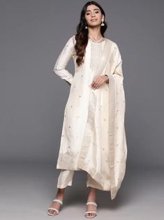 * Floral Woven Design Zari Regular Kurta with Trousers & Dupatta Silk Kurta Set / Pakistani Salwar Kameez / Indian Wedding Dress / Plus Size Cotton Dress / Traditional Indian Wear / Salwar Kameez Dupatta / Kurti Palazzo Set    * Cream-coloured woven design Kurta with Trousers with dupatta *Kurta design:- * Floral woven design * Straight shape * Regular style * Round neck, three-quarter regular sleeves * 2 pockets zari detail * Calf length with straight hem * Silk blend fabric * Trousers design:- Dola Silk Kurta With Dabka Work For Weddings, Elegant Straight Kurta In Dola Silk, Elegant Dola Silk Straight Kurta Traditional Wear, Elegant Dola Silk Straight Kurta, Festive Off White Straight Kurta Set, Elegant Art Silk Sets For Navratri, Off-white Zari Work Straight Kurta Set, Transitional Chanderi Dresses For Weddings, Elegant Straight Kurta For Wedding