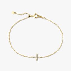 Our Esther Dainty Diamond Cross Bracelet is a glimmering beacon of faith. Stylish and elegant, this bracelet embodies the beauty of His grace. Perfect to shine on its own but sophisticated enough to add to a stack. The intentional delicacy of this design makes for the heartfelt gift of a child's first piece of fine jewelry or an adult's everyday dainty wear. Metal: 18k White Gold / 18k Yellow Gold / 18k Rose Gold Round Brilliant Cut Natural Diamonds: Approx. 0.10 ctw G Color and SI1-2 Clarity Diamonds Length: 7 inches at the longest. ﻿Adjustable sliding bead to provide options for smaller wrist size. Closure: Lobster clasp Measurements: Approx. 11.7mm length x 5.9mm width Looking for a different size? Please email us. Elegant Adjustable Cross Bracelet, Elegant Yellow Gold Rosary Bracelet With Cross, Elegant Yellow Gold Cross Rosary Bracelet, Collar Chain, Mens Engagement, Bridal Bands, Diamond Cross, Band Bracelet, Cross Bracelet